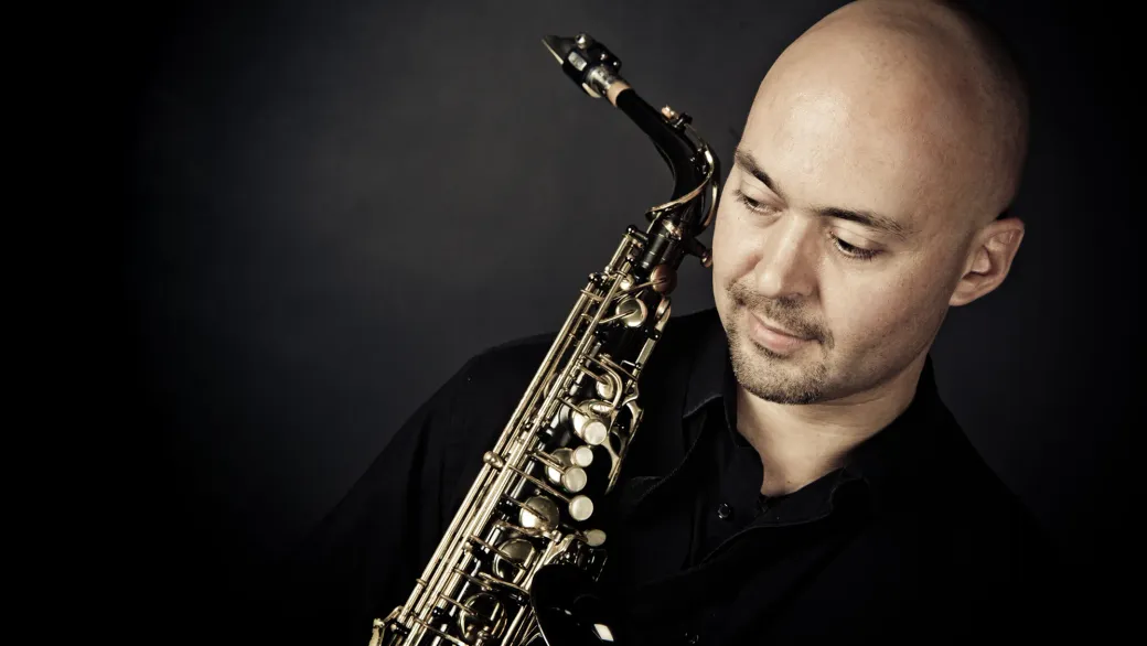 Adrian Sanso-Ali on stage with his saxophone
