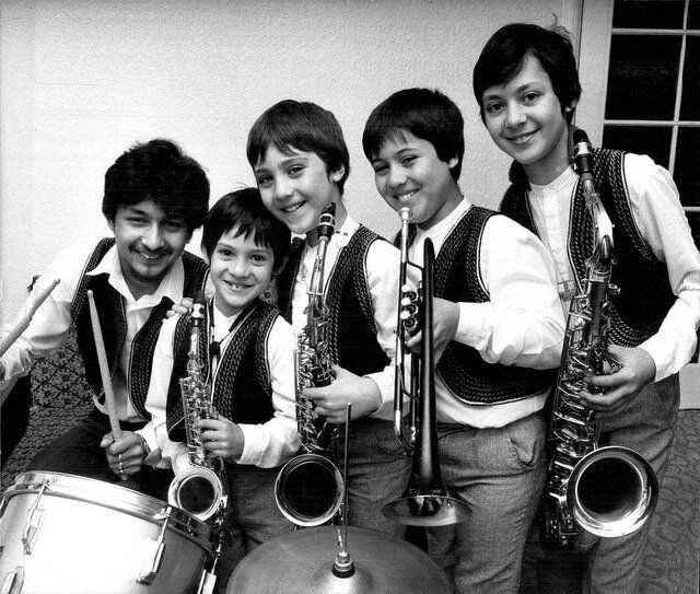 The five Rossello brothers as children, holding their instruments
